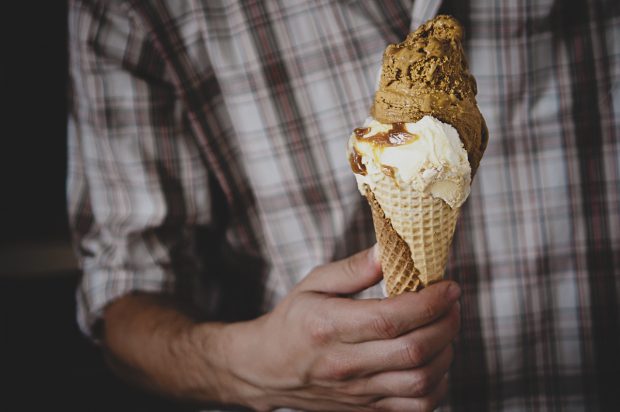 Guy holding double ice cream scoop cone