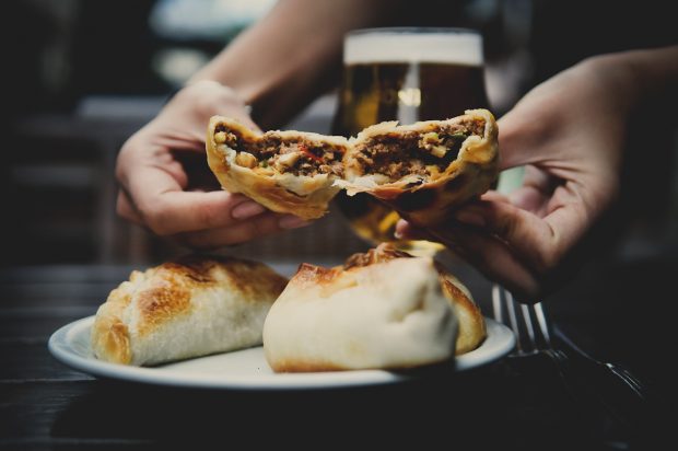 empanada broken open and shown for tasting