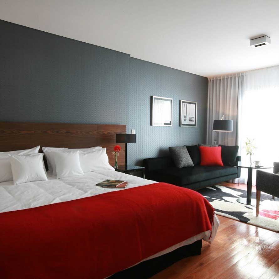 Interior of modern hotel room, bed, desk and chair