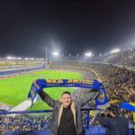 Tourist holding Boca Juniors scarf inside La Bombonera
