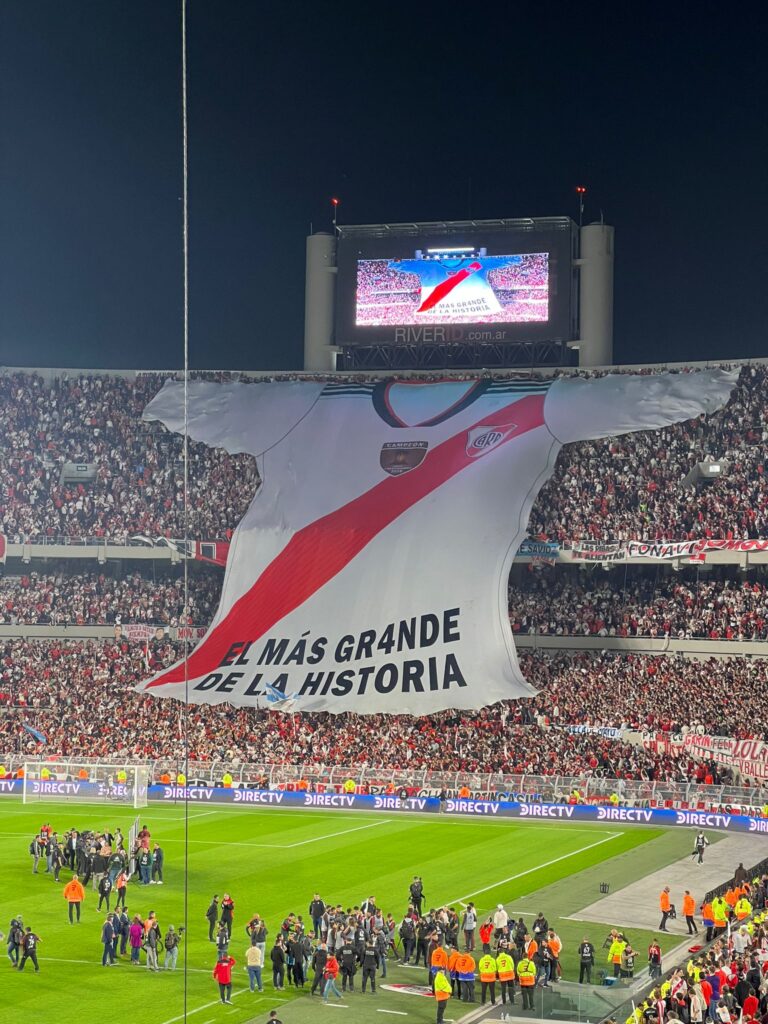 Massive River Plate jersey held by crowd in El Monumental stadium